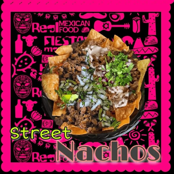 A plate of The Taco Shop's street nachos with meat, cheese, onions, cilantro, and a pepper.