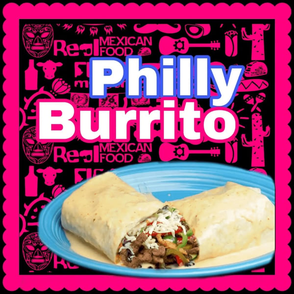 A Philly Burrito from The Taco Shop, cut in half, revealing steak, peppers, and cheese.
